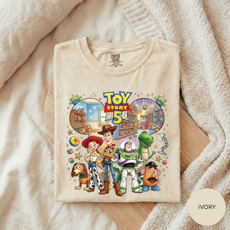 A t-shirt featuring characters from the Toy Story movie, including Woody, Buzz Lightyear, Lassie, and other beloved characters from the film.
