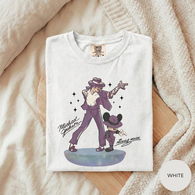 A white t-shirt with a graphic design featuring a man and a child, along with the text "Michael Jackson" and "Mickey Mouse".
