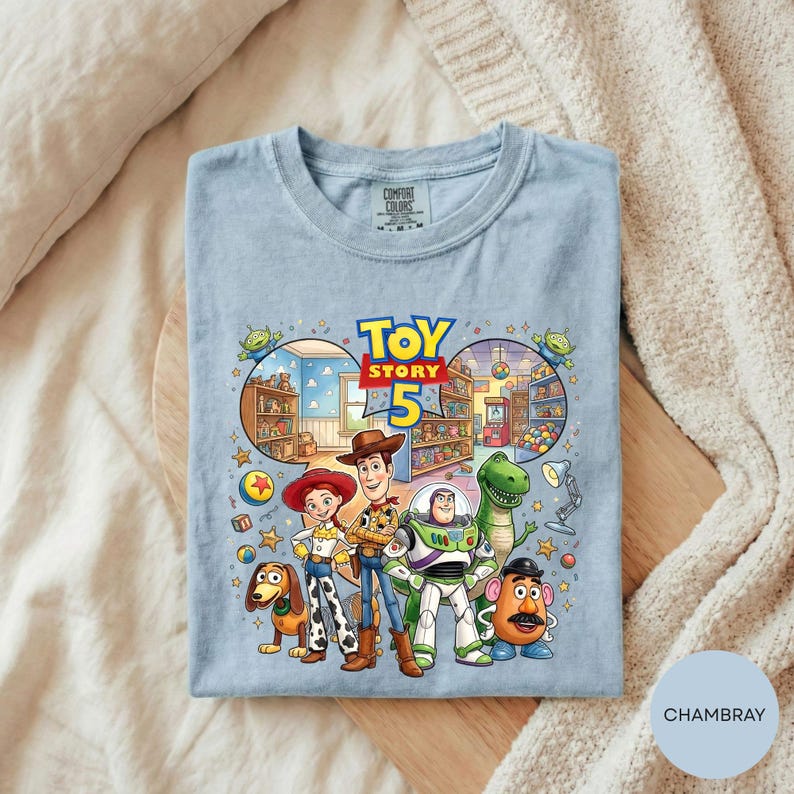 A t-shirt featuring characters from the Toy Story movie, including Woody, Buzz Lightyear, Timmy, and Pooh, along with various other toys and elements from the story.