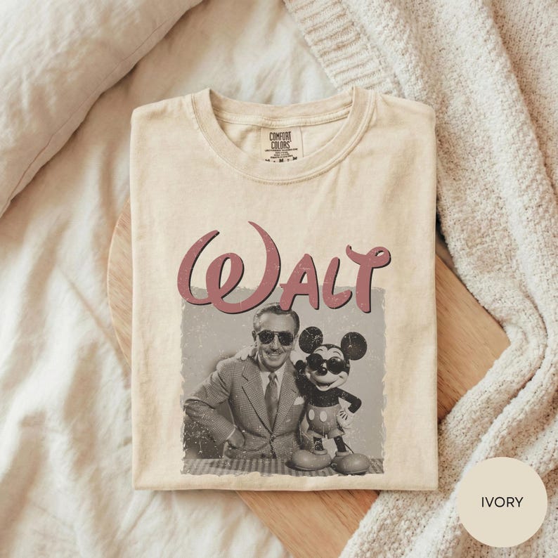 A t-shirt with a graphic design featuring a man and a character, likely Mickey Mouse, along with the word "Walt".