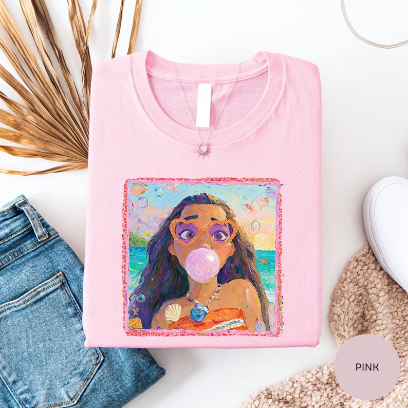 a pink t-shirt with a colorful illustration of a young girl blowing a bubble gum bubble, surrounded by various clothing items and accessories.