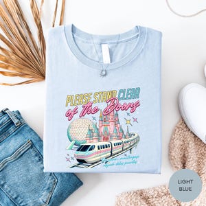 a blue tshirt with a picture of a train and a castle on it