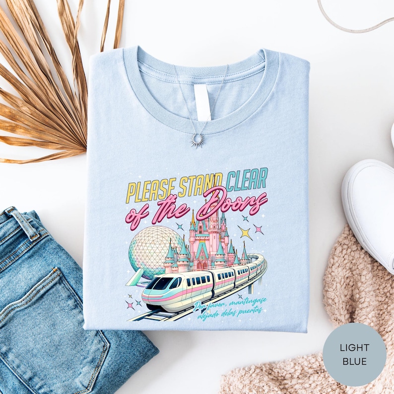 a blue tshirt with a picture of a train and a castle on it