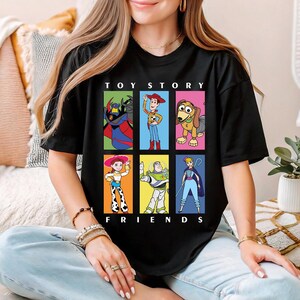a woman sitting on a couch wearing a toy story friends shirt