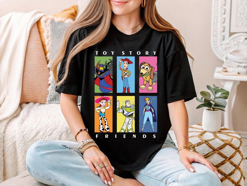 a woman sitting on a couch wearing a toy story friends shirt