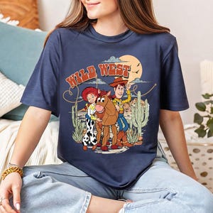 a woman sitting on a couch wearing a t - shirt