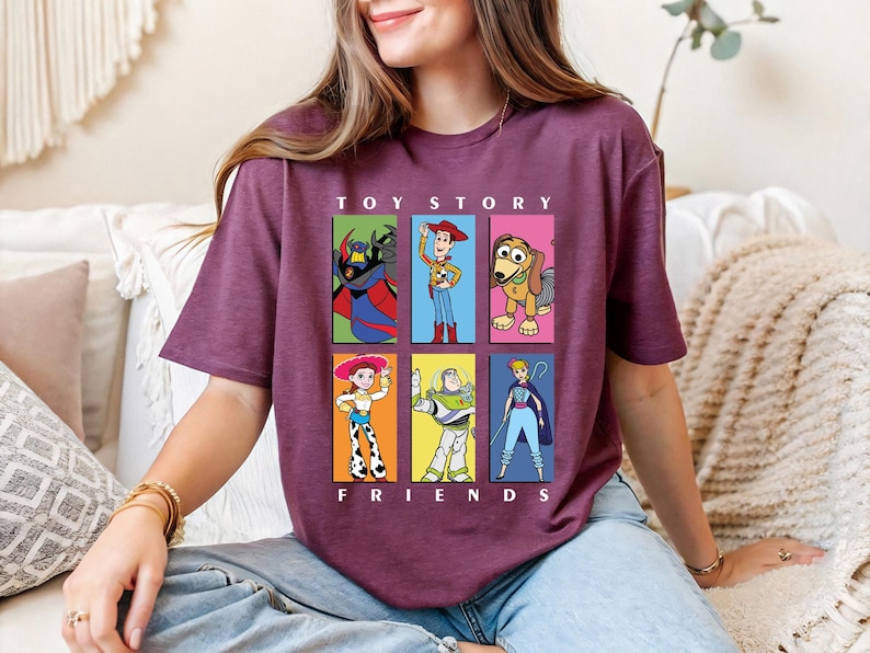 a woman sitting on a couch wearing a toy story t - shirt