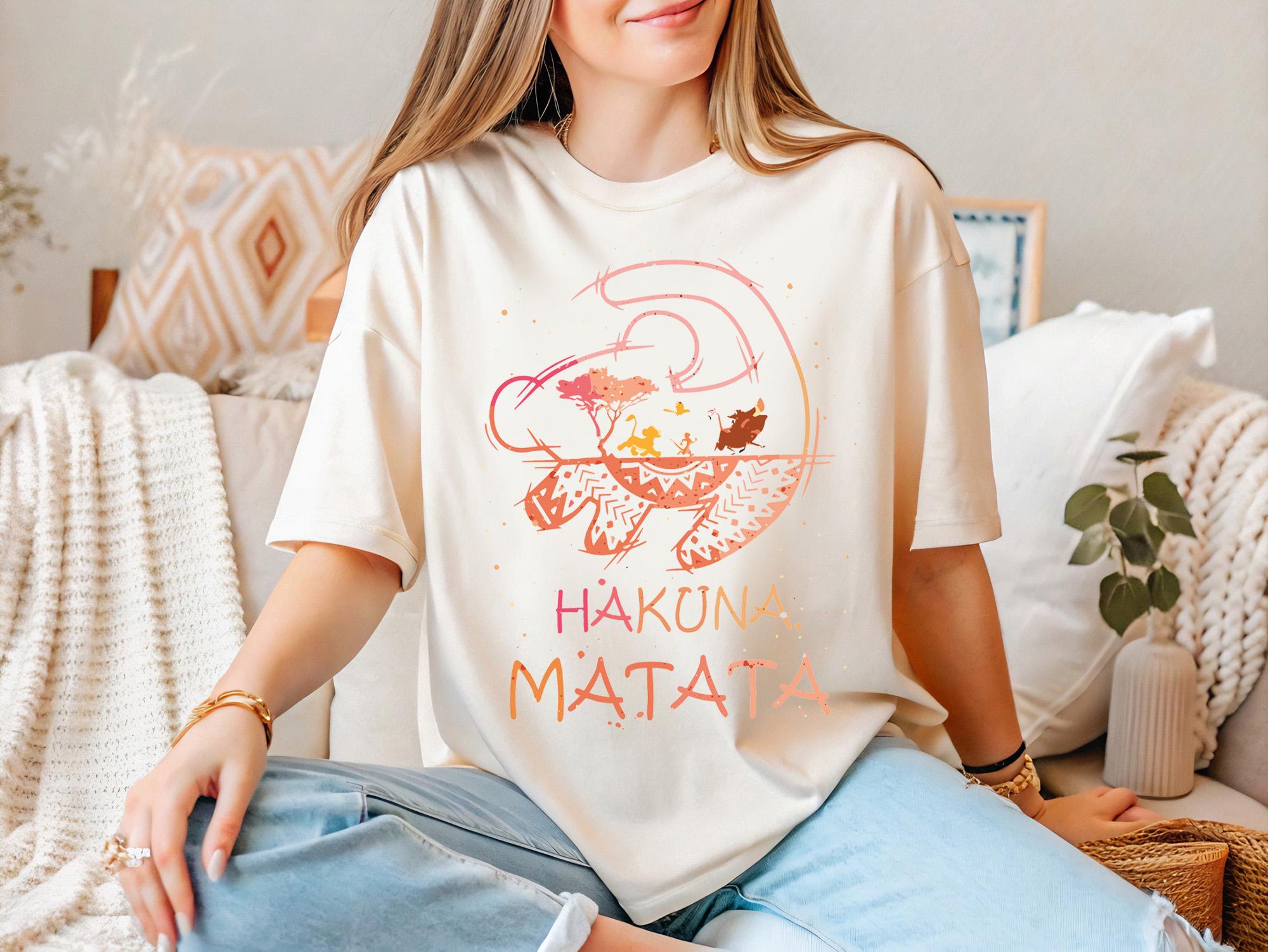 a woman sitting on a couch wearing a t - shirt