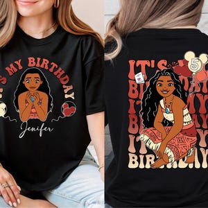 a woman wearing a black shirt with a picture of a woman on it