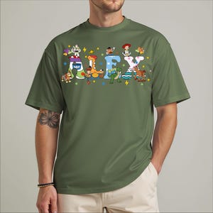 A man wearing a green t-shirt with the name "ALEX" printed on it in a playful, cartoon-like font.