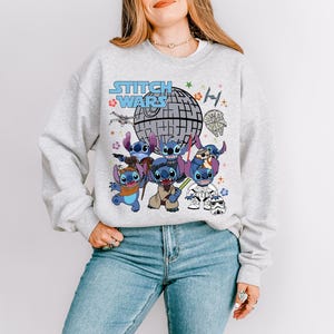 a woman wearing a sweatshirt with stitching on it