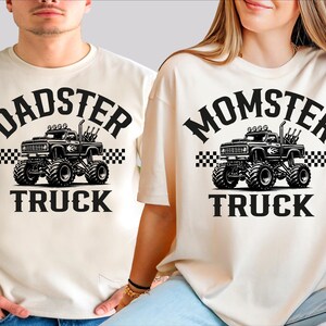 two people wearing matching t-shirts with a graphic design of a monster truck.