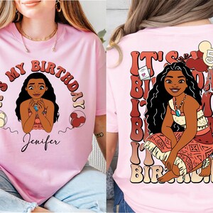a woman wearing a pink shirt with a picture of a woman on it