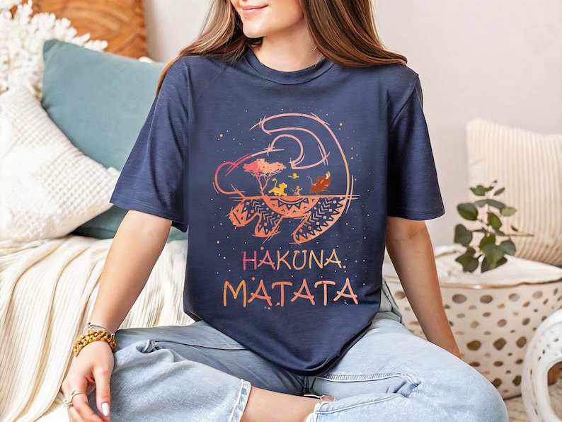 a woman sitting on a bed wearing a t - shirt that says hakkana