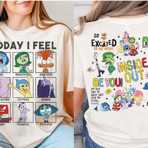 May include: Cream-colored t-shirt featuring characters and text from the movie "Inside Out." The front displays a grid of emotions with the words "Today I Feel." The back has more characters and the words "Inside Out" and "Be You!"