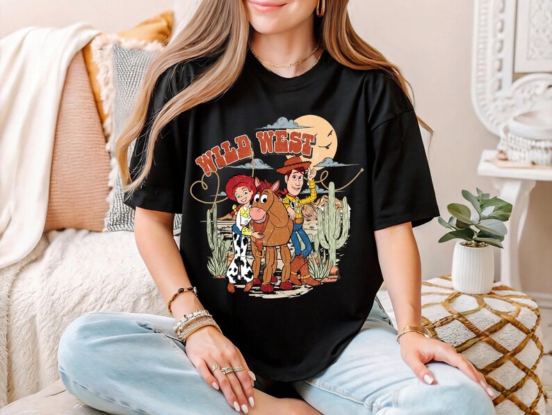 a woman sitting on a bed wearing a black shirt