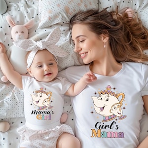 May include: White t-shirts with matching graphics featuring a teapot and teacup design. The baby's shirt says "Mama's Girl" and the adult's shirt says "Girl's Mama". The baby wears a white headband with a bow.