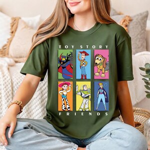 a woman sitting on a couch wearing a toy story t - shirt
