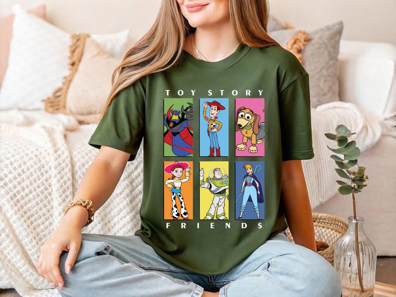 a woman sitting on a couch wearing a toy story t - shirt