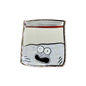 May include: A silver enamel pin of a white plastic bag with a red stripe across the top. The bag is filled with a glittery substance and has a cartoon face with wide eyes and a large mouth.