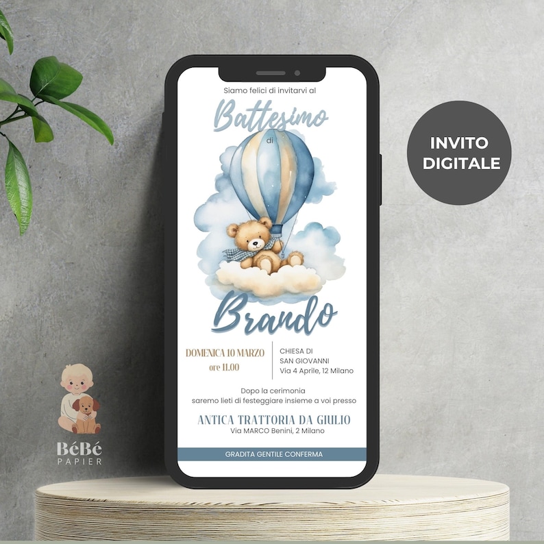 May include: A digital invitation for a baby boy's baptism. The invitation features a blue and white hot air balloon with a teddy bear holding a blue blanket. The text on the invitation reads "Battesimo di Brando" and includes the date, time, and location of the baptism. The invitation also includes the text "INVITO DIGITALE".