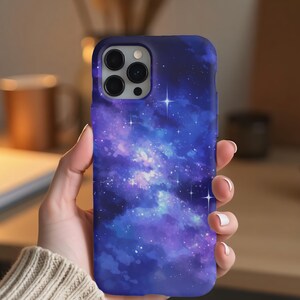 May include: A blue and purple galaxy phone case with white stars. The case has a camera cutout and is made of a soft, flexible material.