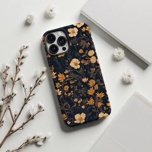 May include: A black phone case with a floral pattern. The flowers are yellow and orange and are on a dark blue background.