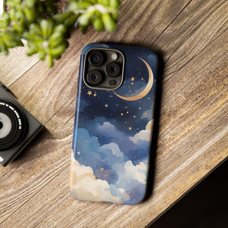 May include: A smartphone case featuring a watercolor night sky design. The case has a dark blue background with white and blue clouds, gold stars, and a gold crescent moon. The case has a glossy finish and a camera cutout.