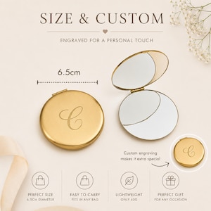 May include: A round gold-colored compact mirror with a letter C engraved on the lid. The mirror is shown closed and open, revealing two reflective surfaces. Text includes SIZE & CUSTOM, ENGRAVED FOR A PERSONAL TOUCH, 6.5cm, and 60g.