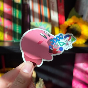 Lindo videojuego rosa con forma de gota que come objetos STEM