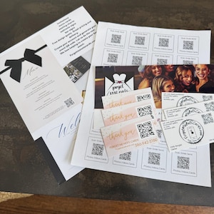 May include: A collection of printed materials, including menus, welcome signs, and thank you cards. The menu features a black bow design. The cards include QR codes and the text "Forget Me Nots Cards".