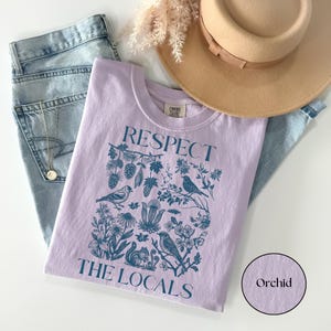 Respect The Locals Comfort Colors shirt featuring vintage wildlife and botanical illustration with birds, flowers, pinecones, and squirrel design, nature lover graphic tee on orchid yellow shirt.