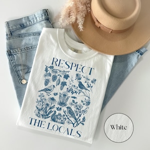 Respect The Locals Comfort Colors graphic tee with detailed botanical and wildlife artwork, vintage national park inspired nature lover shirt styled with jeans and hat.