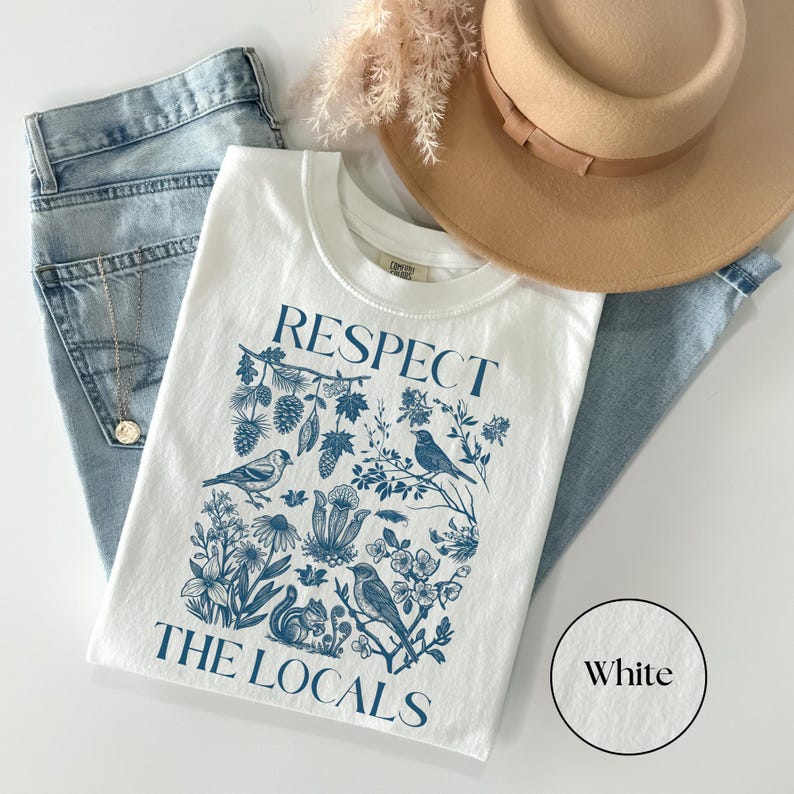 Respect The Locals Comfort Colors graphic tee with detailed botanical and wildlife artwork, vintage national park inspired nature lover shirt styled with jeans and hat.