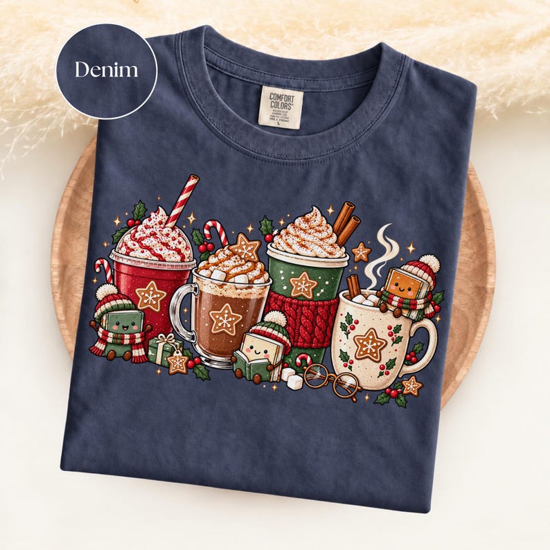 Folded Denim navy Comfort Colors shirt featuring a bright Christmas reading illustration with red, green and cream hot cocoa mugs, whipped cream, candy canes, gingerbread cookies and adorable book characters wearing winter hats and scarves.