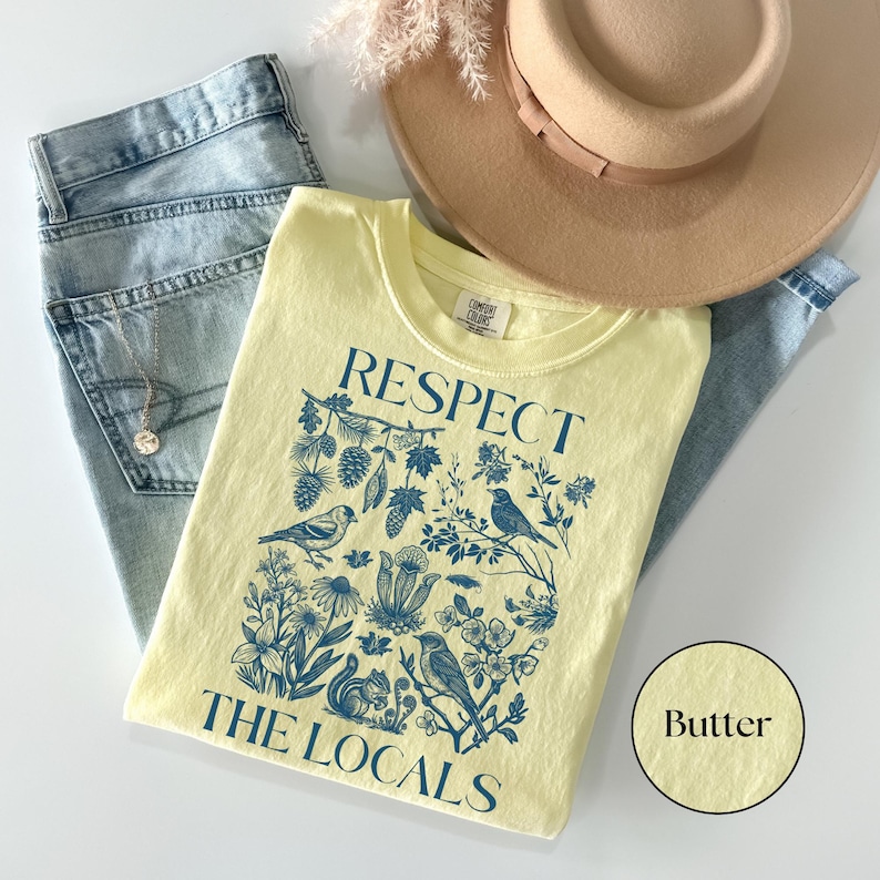Respect The Locals Comfort Colors shirt featuring vintage wildlife and botanical illustration with birds, flowers, pinecones, and squirrel design, nature lover graphic tee on butter yellow shirt.