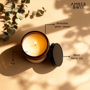 Infographic detailing the 9oz candle's features, including the reusable amber glass vessel and the black metal screw-top lid.