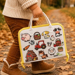 May include: A rectangular white carrying case with yellow trim featuring colorful cartoon illustrations of a red tractor, a barn, a pig, a horse, a sheep, a dog, a chicken, baskets of produce, and gardening tools, with the text epok PLAY.