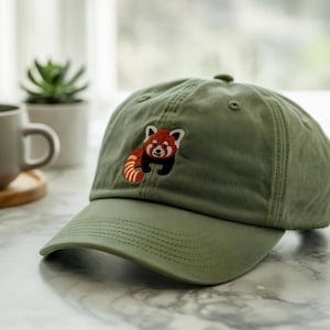 Curious Red Panda Peeking Out on This Soft Green Embroidered Hat