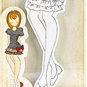 May include: A cling stamp featuring a stylized female figure in a dress with a bow. The stamp is white with black outlines. The packaging includes the text "CLING STAMP" and the brand name "Julie Nutting".