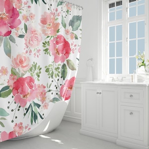 May include: A white shower curtain with a pink and green floral pattern. The shower curtain is made of a soft, water-resistant fabric and features a watercolor-style design.