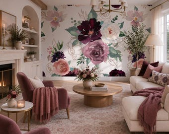 May include: A wall mural featuring a large-scale watercolor floral pattern with deep burgundy, dusty rose, and white blossoms accented by green foliage and gold line-art outlines on a white background, displayed in a furnished living room.