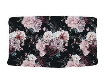 May include: A black background with a repeating pattern of pink, white, and burgundy roses. The roses are arranged in a cluster with green leaves and stems.
