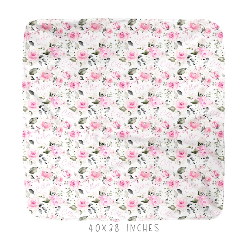 May include: A white baby blanket with a floral pattern of pink roses and green leaves. The name "Callie" is repeated throughout the design in a pink script font. The blanket measures 40 x 38 inches.
