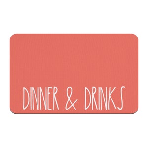 May include: A coral-colored rectangular sign with the text "DINNER & DRINKS" in white.