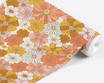 May include: A roll of wallpaper with a retro floral pattern featuring orange, pink, and yellow flowers on a cream background.