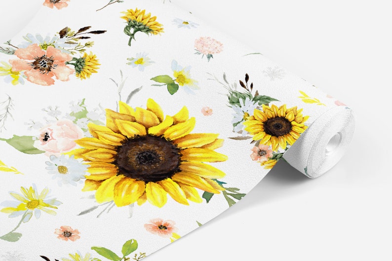 May include: A roll of white wallpaper featuring a watercolor floral pattern. The design includes large yellow sunflowers with dark brown centers, smaller white daisies, and soft peach-colored blossoms, all accented with green leaves and stems.