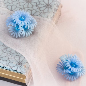 1950s light blue soft plastic flower earrings image 1