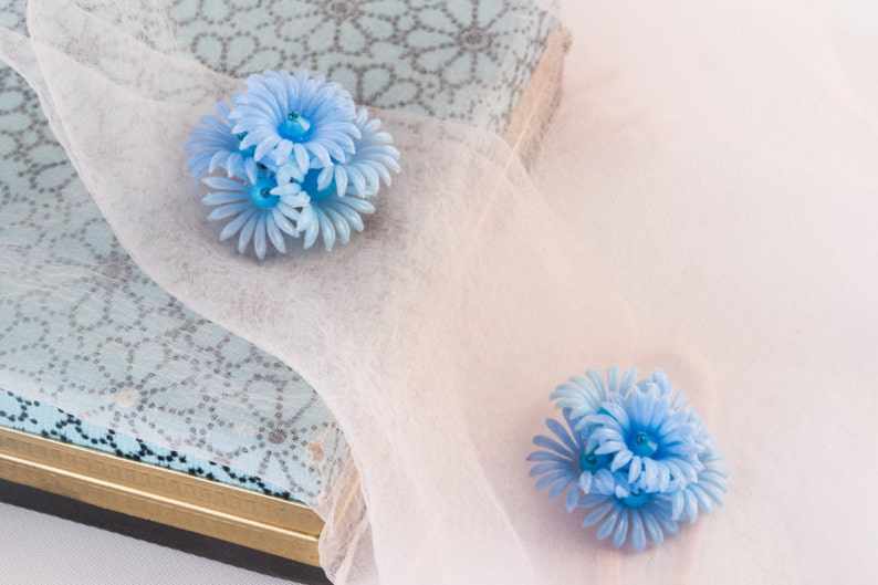1950s light blue soft plastic flower earrings image 1
