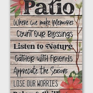 May include: Rectangular wooden sign with the words "welcome to our Patio" in black script. The sign includes phrases like "Where we make Memories" and "Relax & Chill." Floral and leaf accents in red and green decorate the corners.